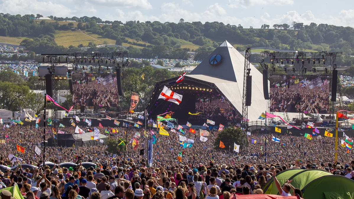 Glastonbury Festival,  Michael Eavis,  music festivals,  Somerset,  Marc Bolan,  The Kinks,  flower power era,  music history,  counterculture,  music and community