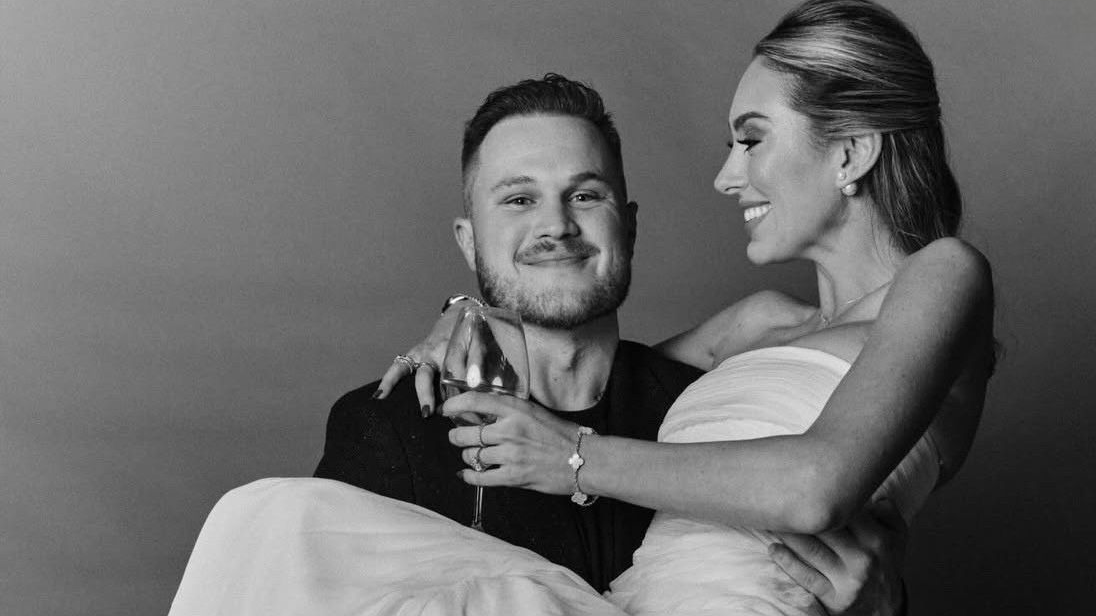 Zach Bryan Samantha Leonard wedding photos 2026,  Zach Bryan Tougher Than the Rest Instagram post,  Samantha Leonard wedding dress feather hem details,  Zach Bryan married in San Sebastian Spain 2026,  Zach Bryan Samantha Leonard relationship timeline 2025,  Zach Bryan New Year&rsquo;s Eve wedding video getaway car,  Bruce Springsteen Tougher Than the Rest Zach Bryan cover,  Samantha Leonard NYU UCLA interior architecture student,  Zach Bryan Spain Running of the Bulls Samantha Leonard,  Zach Bryan formal wear Black Eyed Peas caption